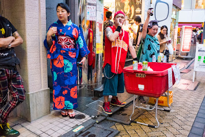 "Stop and buy!" - streetside vendor at the 60th Koenji Awa-Odori Festival, 2016, Tokyo, Japan. Street stall at the 60th Koenji Awa-Odori Festival, Tokyo, Japan.