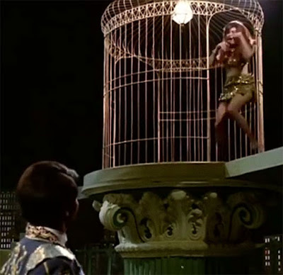 Helen dancing in a gilded cage in the Bollywood film Caravan