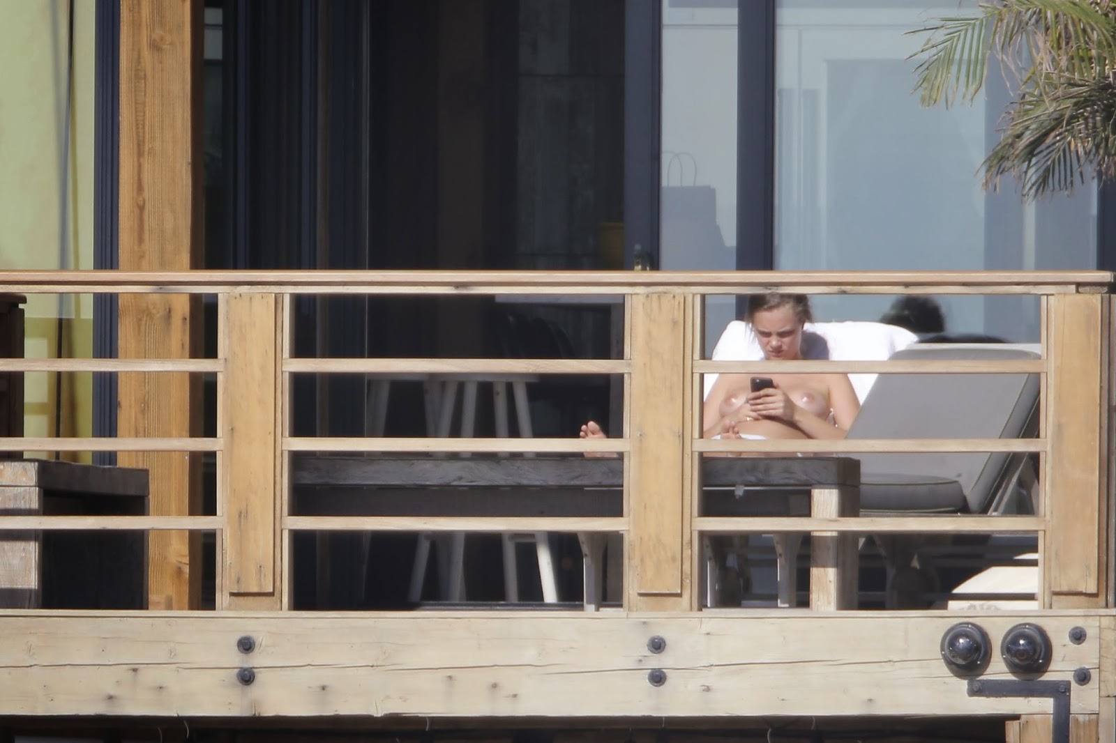 Cara Delevingne Bikini Photos Sunbathing On A Balcony.