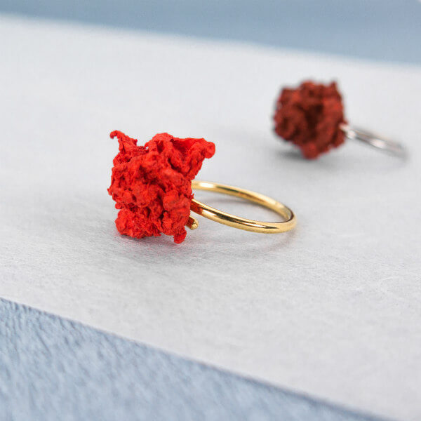 pair of red paper pulp rings, one silver and one gold