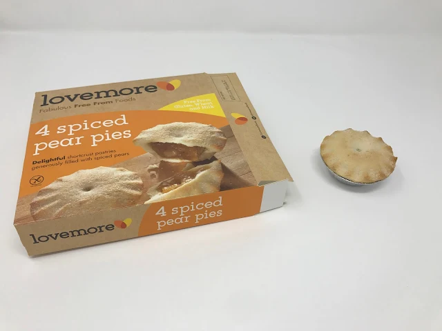 a box of lovemore spiced pear pies open next to a pie