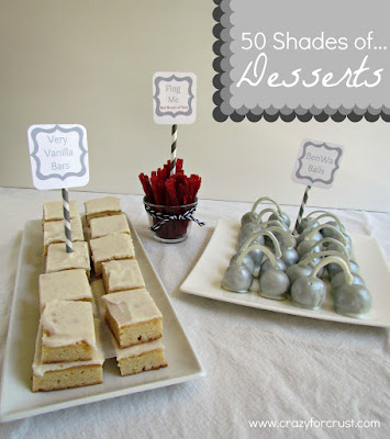 Very vanilla bars on a white tray with silver cake balls and red licorice.