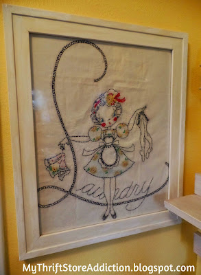 Framed vintage embroidered laundry bag creates the perfect art next to the laundry room door: mythriftstoreaddiction.blogspot.com Vintage embroidered laundry bag