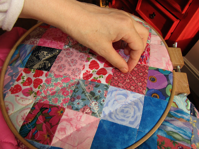 Sewing a quilt by hand