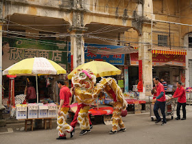 Lion dance troupe on a street in Jiangmen