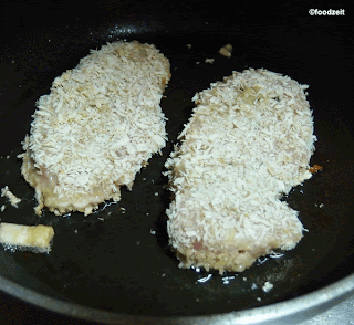 Frying the Schnitzel on low flame to solidify the coating