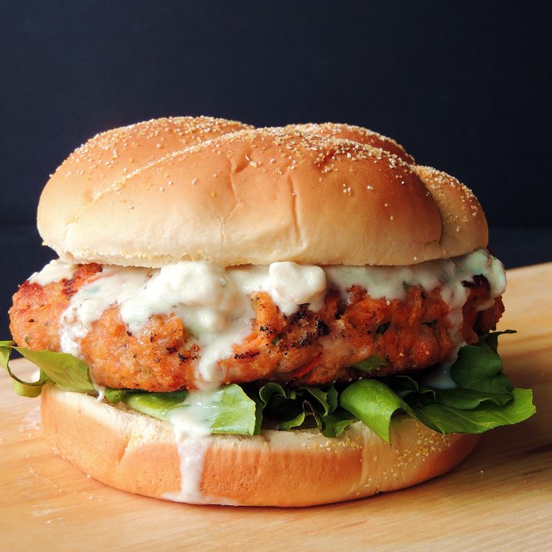 Buffalo Chicken Burgers - Buffalo chicken wings and burgers collide in this mouth-watering Buffalo Chicken Burger with Creamy Blue Cheese Sauce recipe, with the bonus of no messy fingers! #BBQ #grilling #grilled #burger #Burgers #chicken #buffalo #keto #lowcarb #easy #recipe | bobbiskozykitchen.com