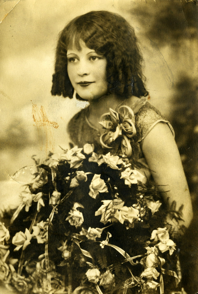 Young girl with flowers, circa 1920 Vintage Everyday