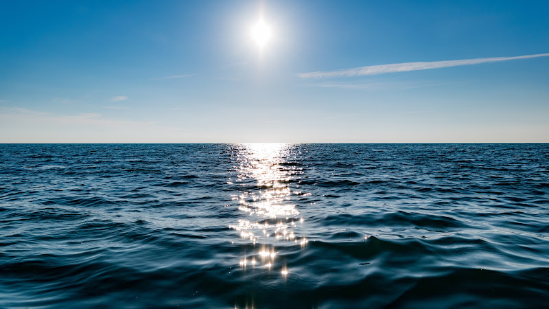 Sun on Blue Sky is reflected in Water