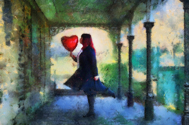 Girl kissing a heart shaped balloon