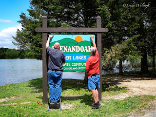 men putting up a sign