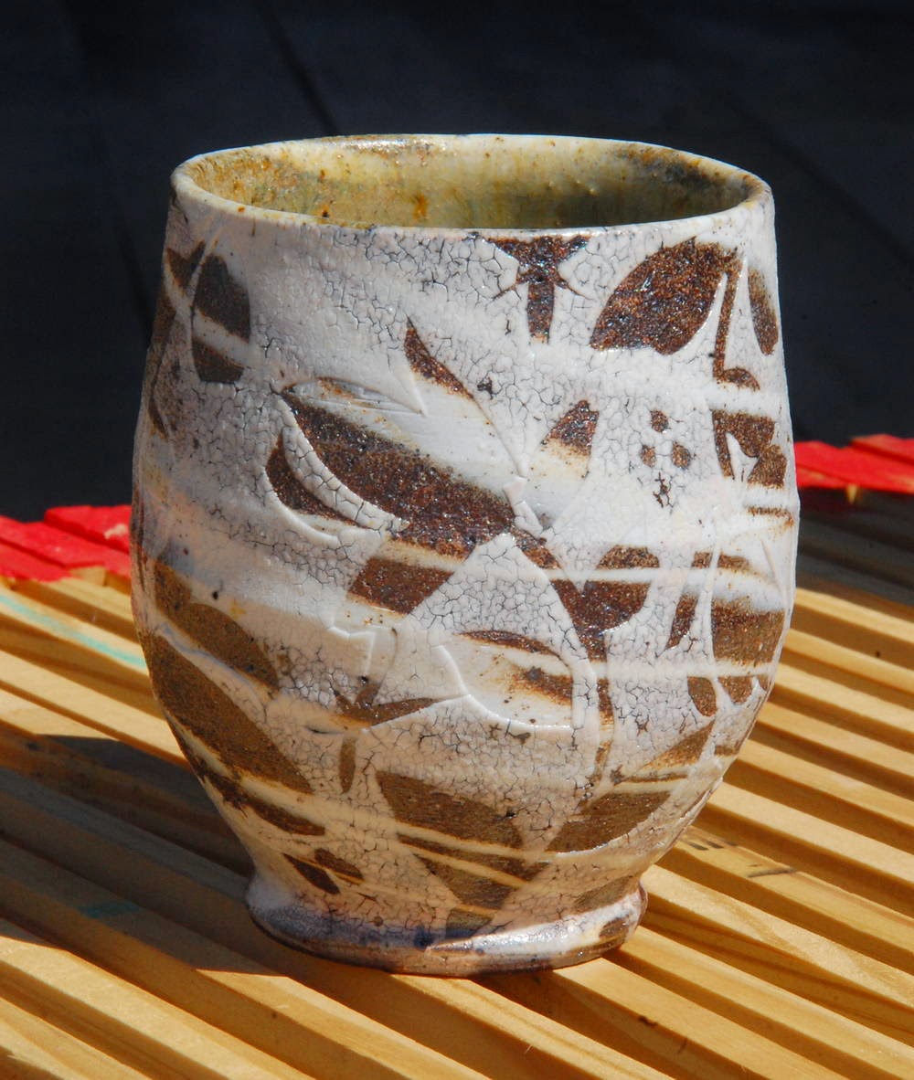 yunomi for AKAR Design Gallery with wax resist swirlware floral motifs porcelain local native clay pottery