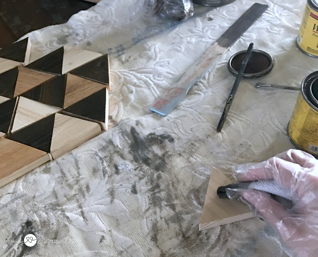 staining triangle pieces to make a geometric pattern