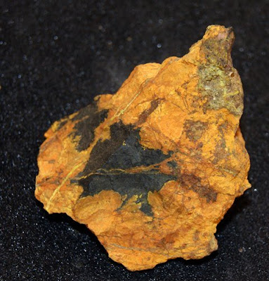 A piece of mineral with black and orange colouration.