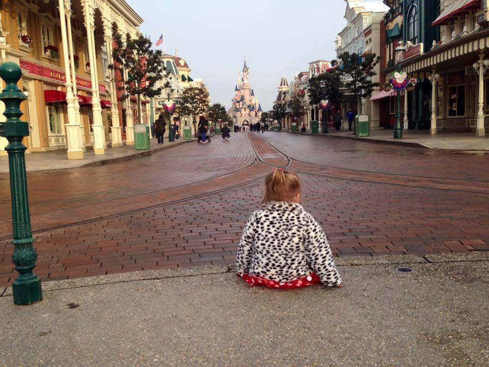 Kairi sitting in front of the castle on main street