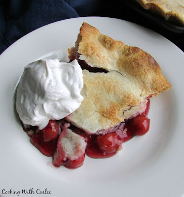 slice of cherry pie with fresh whipped cream