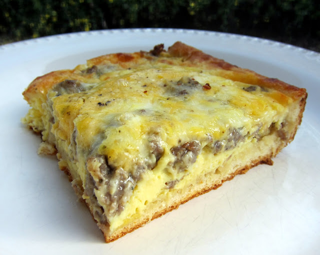Breakfast Bake - crescent rolls topped with sausage, eggs, milk, cheddar and mozzarella cheese. SO good! Ready in 30 minutes. Great for a potluck.