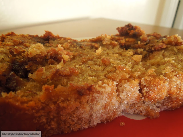 close up view of a slice of Reeses Peanut Butter Cup Banana Bread on a white plate with a red napkin