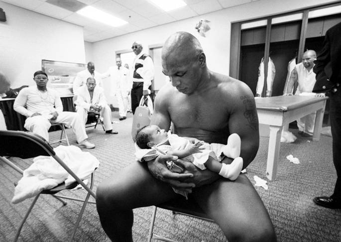 Mike Tyson with his two-month son Miguel after losing to Lennox Lewis, 2002