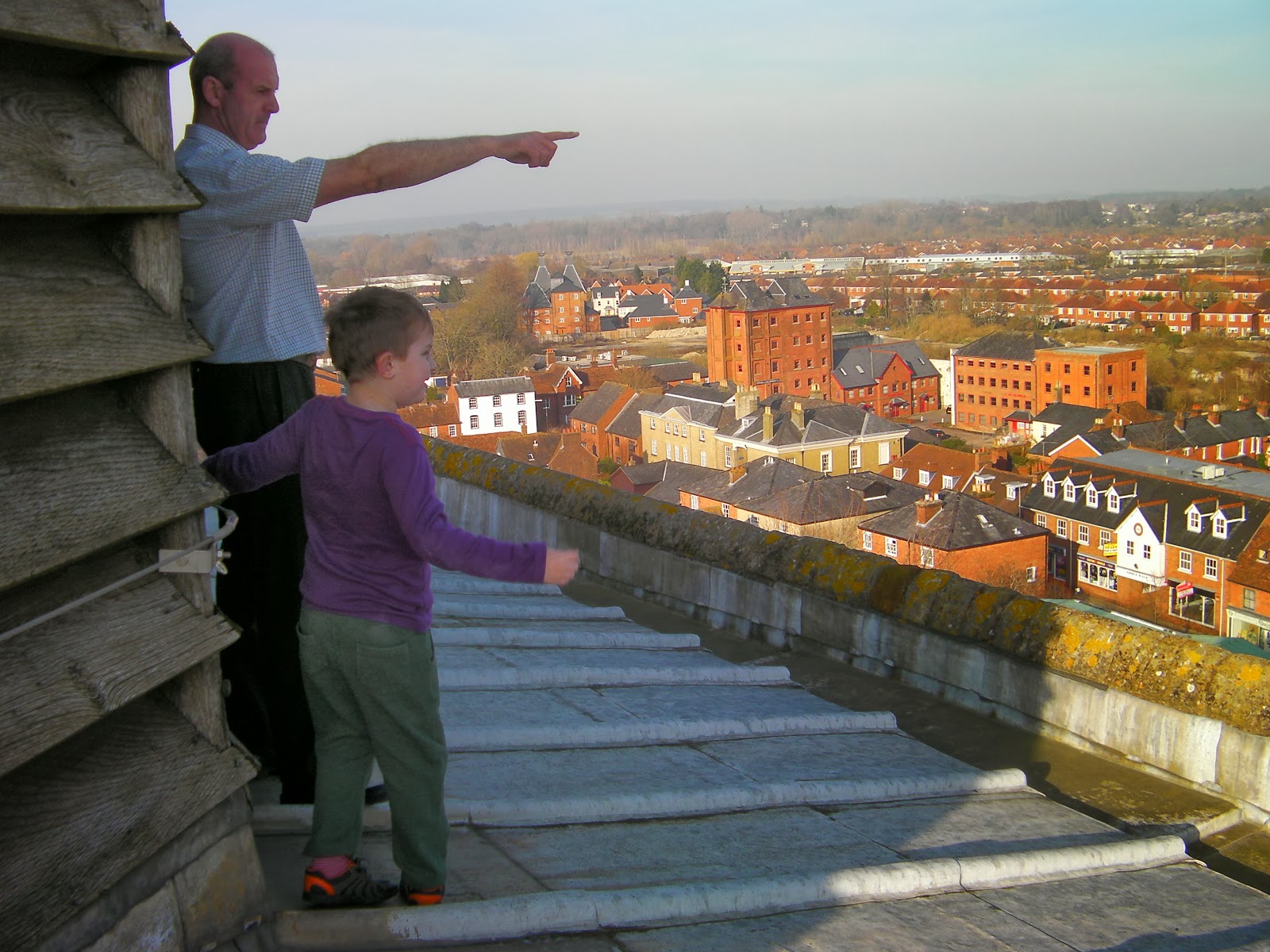 verger of romsey abbey pointing out romsey civic offices view from romsey abbey roof