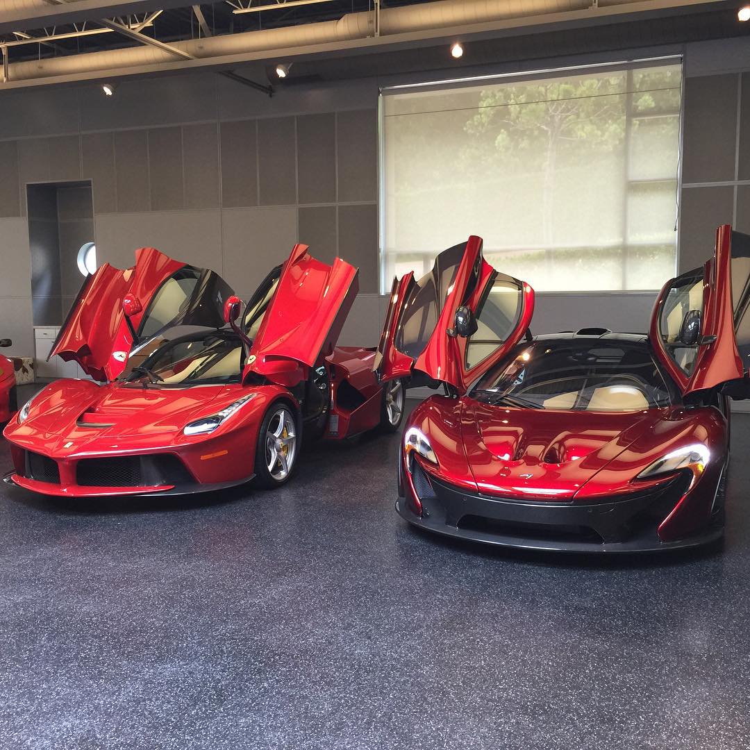 Two red wrapped supercars LaFerrari and McLaren P1 are