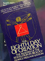 The Eighth Day of Creation, superimposed on the cover of Intermediate Physics for Medicine and Biology.