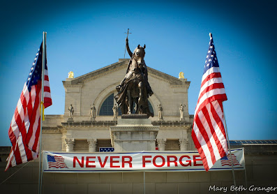 9/11 remembrance day in St. Louis, American flags flying with never forget banner