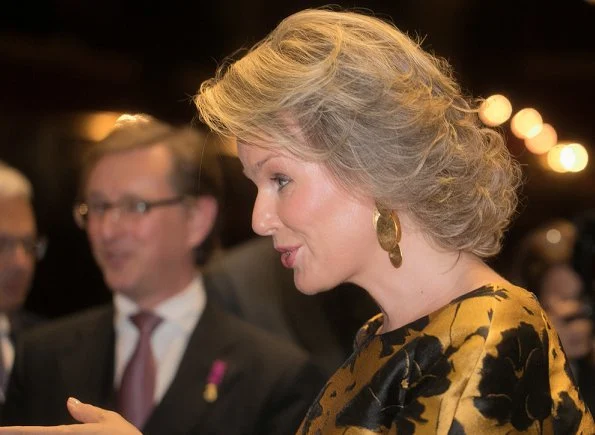 Queen Mathilde wore Natan trousers and Natan blouse and she wear Tikli Jewelry gold pleated drop earrings and cuf bracelet