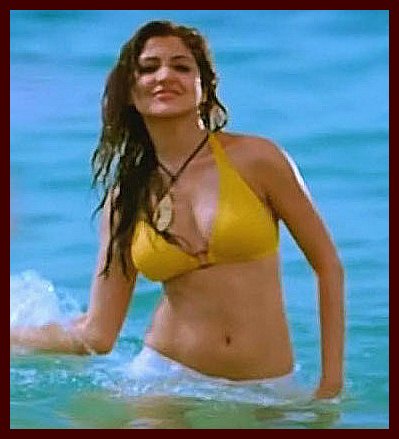 Playful Anushka Sharma in the sea wearing a yellow bikini and white shorts