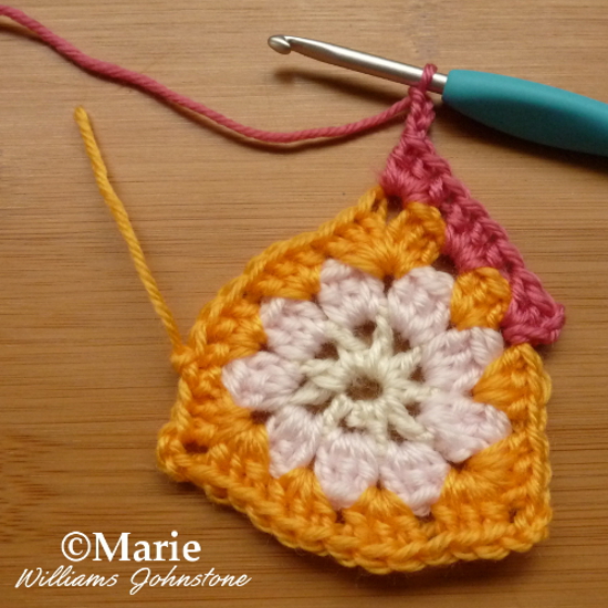 Working a different colored round of crochet in red yarn