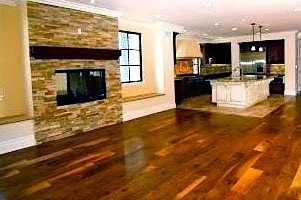 Living room with hardwood floor and fireplace remodel example.