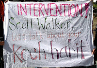 banner on a sheet saying, This is an intervention Scott Walker.  Let's talk about your Koch habit.