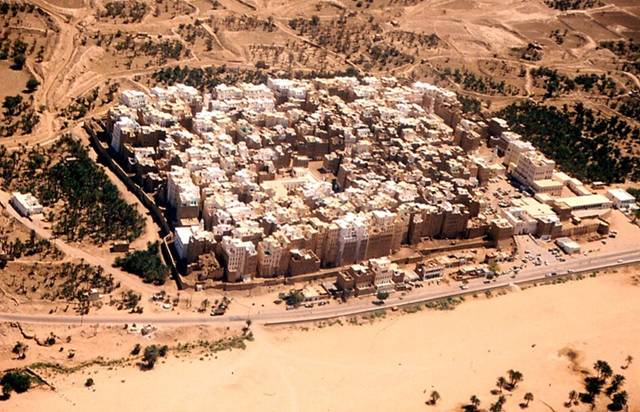 The city of Shibam, located in the central-western area of Hadhramaut Governorate, in the Ramlat al-Sab`atayn desert, is best known for its towering mudbrick skyscrapers. This small town of 7000 is packed with around 500 mud houses standing between 5 and 11 stories tall and reaching 100 feet high, all constructed entirely of mud bricks. The bizarre skyline that the high rise buildings bestow upon the city has earned Shibam the moniker "Manhattan of the Desert."