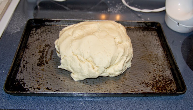 Large ball of shortbread dough on baking tray.