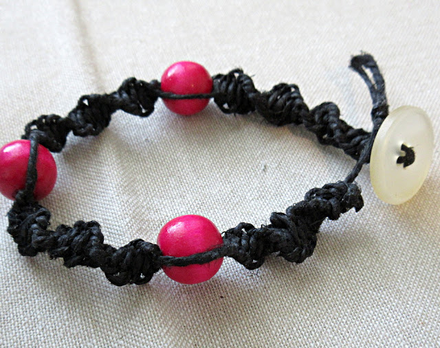 A black and hot pink DNA double helix spiral bracelet. Science jewelry makes a unique birthday or graduation gift for biology teachers or geneticists!