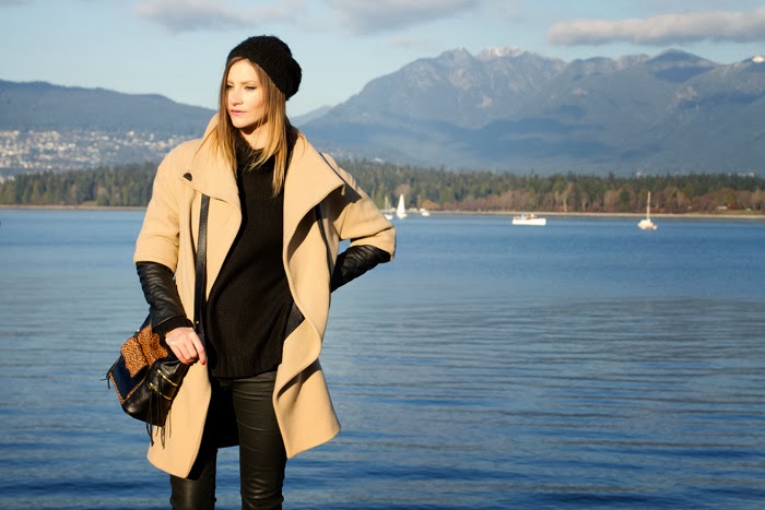 Fashion Blogger, Alison Hutchinson, is wearing a leather sleeve coat from Zara, H&M chunky turtleneck sweater, Current/Elliot wax coated jeans, Vince Camuto tan booties, a Rebecca Minkoff Leopard Print Bag, Michael Kors slim Runway Watch, and a Kate Spade gold bracelet
