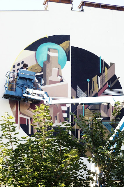street artist jacyndol and seikon working on a new mural