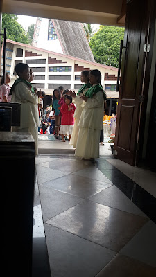 waiting blessing from priest by the children in the isle waiting blessing from priest by the children in the isle