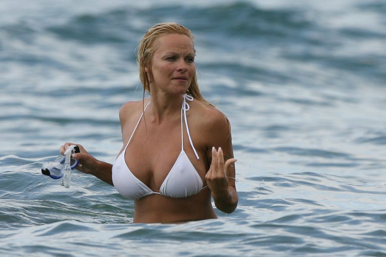 Pamela Anderson Playing in a White Bikini in Beach. 