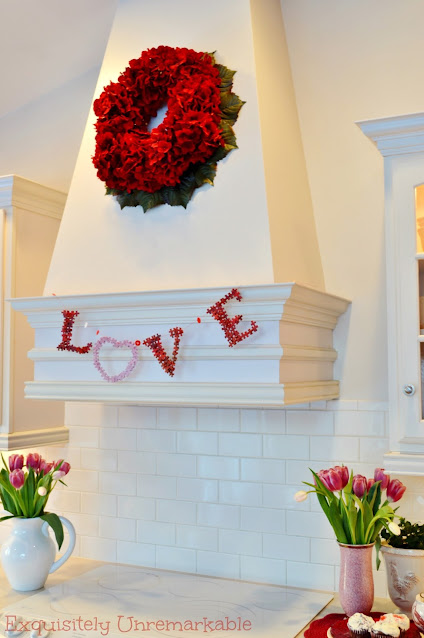 Pink and red love garland made from puzzle pieces on kitchen hood