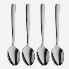 Four metal spoons in a row