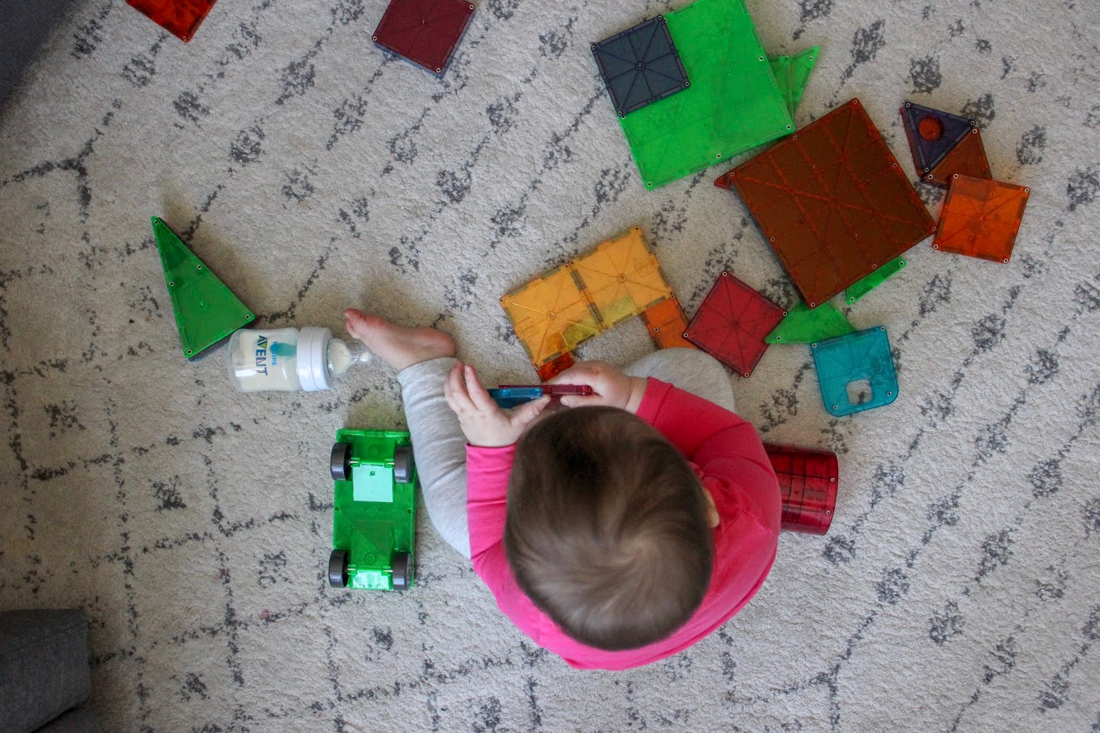 baby playing with magnetic tiles
