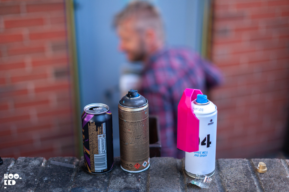 Street Artist My Dog SIghs at work in Cheltenham, UK for the Cheltenham Paint Festival