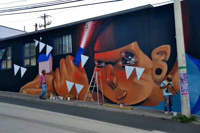 street artist jade working on a new mural