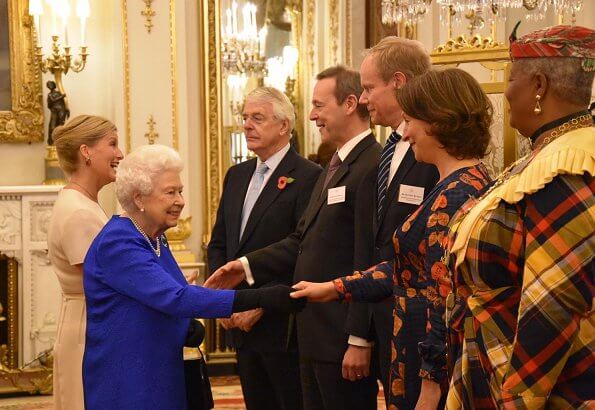 The Queen and Countess of Wessex hosted a reception. Queen wore royal blue dress. Emilia Wickstead skirt, Victoria Beckham top