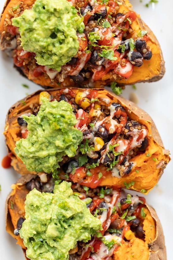 These Mexican Quinoa STUFFED Sweet Potatoes are the ultimate plant-based meal! Packed with fiber and protein, they're filling, tasty and easy to make! #stuffedsweetpotatoes #mexicanquinoa #quinoa #quinoarecipe #vegandinner #simplyquinoa