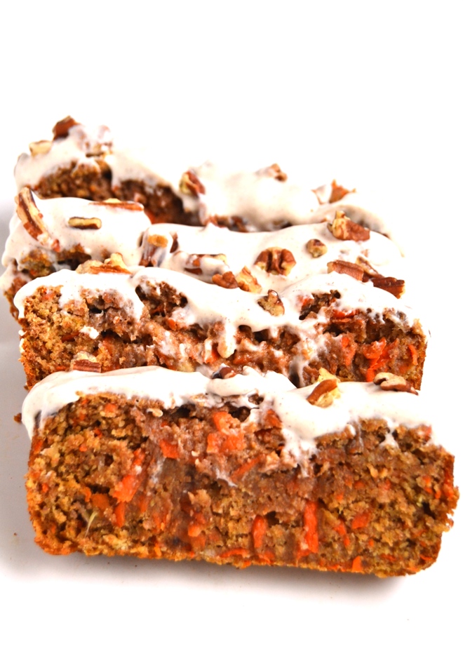 Carrot Cake Banana Bread with Cream Cheese Frosting is a moist and healthy treat that tastes like cake made with whole-wheat flour and apple sauce. It is topped with cinnamon cream cheese Greek yogurt frosting- you won't be able to stop at one slice! www.nutritionistreviews.com