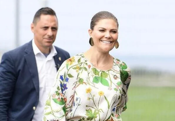 Crown Princess Victoria wore Rodebjer irmaline floral print top and skirt. Caroline Svedbom gold earrings. Prince Felix of Luxembourg