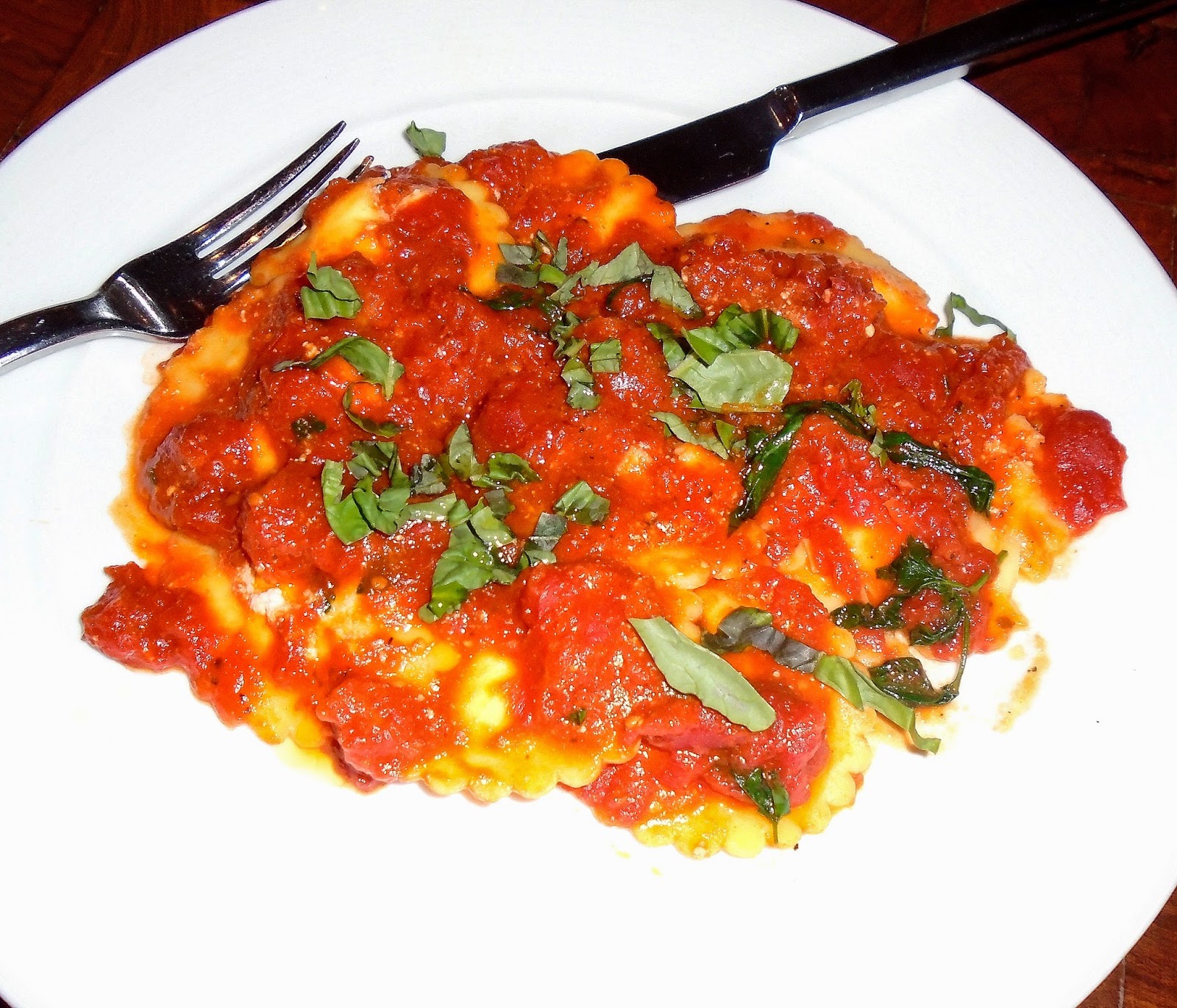 close-up of the gluten-free ravioli and sauce topped with fresh pieces of basil!