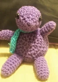 http://www.ravelry.com/patterns/library/purple-stitch-project-sitting-turtle-in-scarf-amigurumi